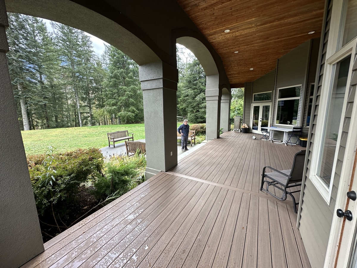 Covered composite deck with cedar ceiling and forest view